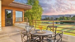 A balcony with a table and chairs, overlooking a golf course and mountains. - JW Marriott's Desert Springs Villas I - Access to Marriott Spa, Sleeps 6-8 (Palm Desert)