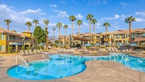 A resort with a pool, palm trees, and multiple-story buildings. - JW Marriott's Desert Springs Villas I - Access to Marriott Spa, Sleeps 6-8 (Palm Desert)