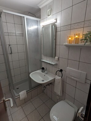 Shower, towels, soap, toilet paper