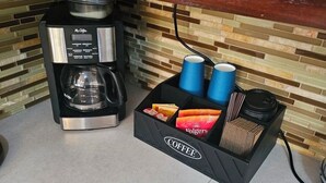 A coffee maker and a coffee station with cups and Folgers coffee packets. - Entire rental unit in Calibishie, Dominica (Calibishie)
