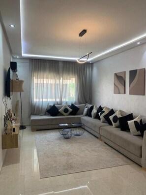 A modern living room with a sofa, a coffee table, and a TV. - Z House Gueliz  Marrakech (Marrakech)