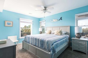 A bedroom with a bed, a desk, a chair, a ceiling fan, and a window with blinds. - Pool, Hot Tub, EV Charger & 2-Min Walk to Beach! (Corolla)
