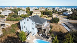 A large house with a pool, surrounded by a wooden deck and a fenced backyard. - New Listing! Pool, Hot Tub & 2-Min Walk to Beach! (Corolla)
