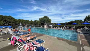 A swimming pool area with lounge chairs and umbrellas. - Pool & Beach Access! 'Lake Arrowhead Hideaway' (Nekoosa)