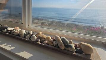 A window sill with a collection of smooth, rounded stones.