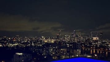 A nighttime cityscape with illuminated buildings.