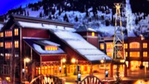 A snow-covered building with multiple windows and a sloped roof, likely a lodge or hotel. - Special Discount: Stay on Main Street for New Year's in 2 Bedroom Villa (Park City)