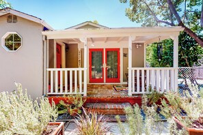 A house with a red door, white porch, and a welcome sign. - Centrally Located! Dog-Friendly San Rafael Home (San Rafael)