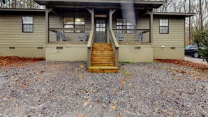 A two-story building with a wooden staircase leading to a door marked "WELCOME". - Dogs Welcome! 'Big Oak Hideaway' Near Lake Martin (Eclectic)