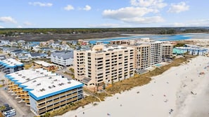 A coastal hotel with multiple buildings, a beach, and a view of the ocean. - #3Dreamscapes Oceanfront Oasis (North Myrtle Beach)