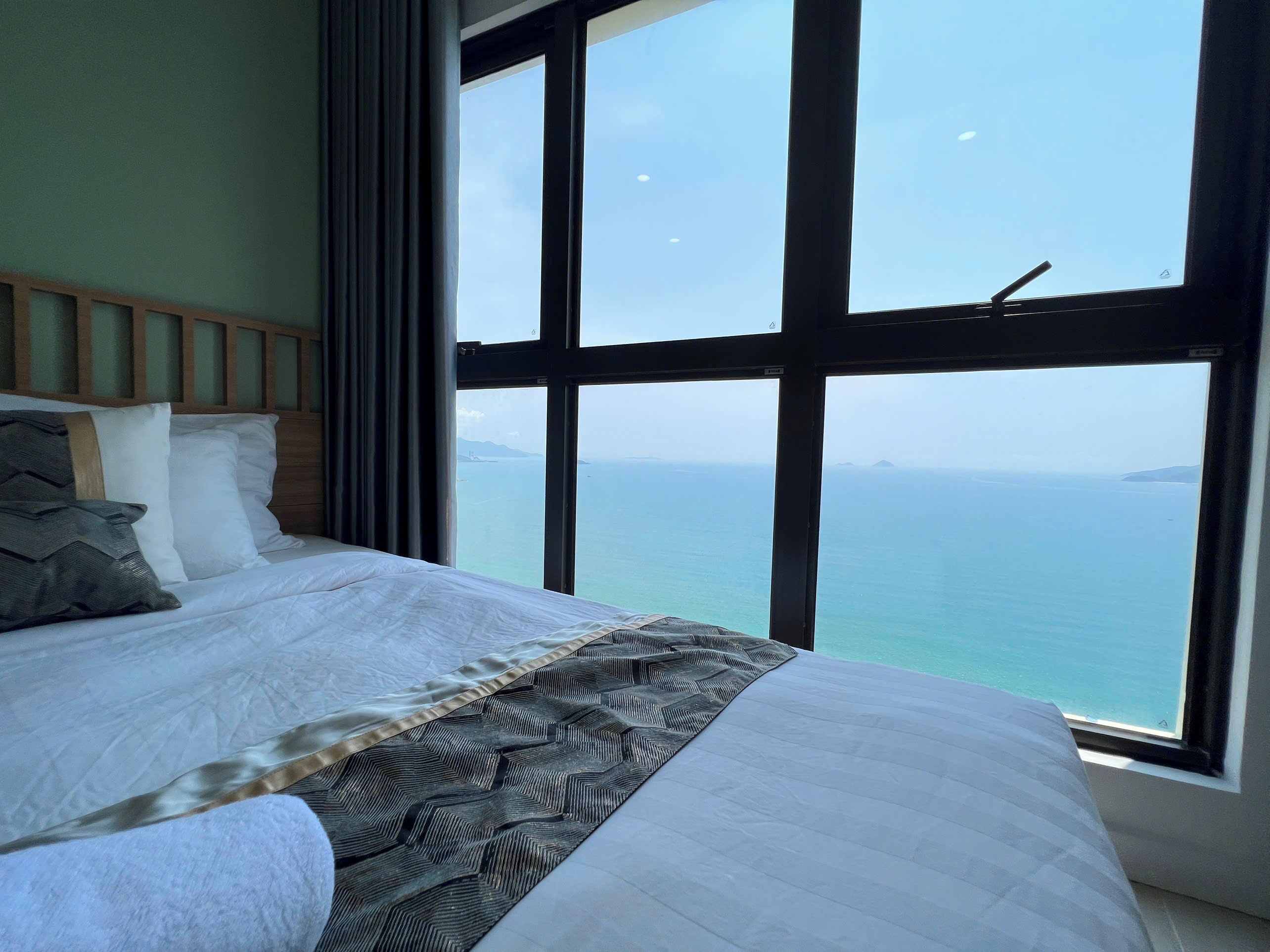 Premium bedding, desk, laptop workspace, blackout drapes