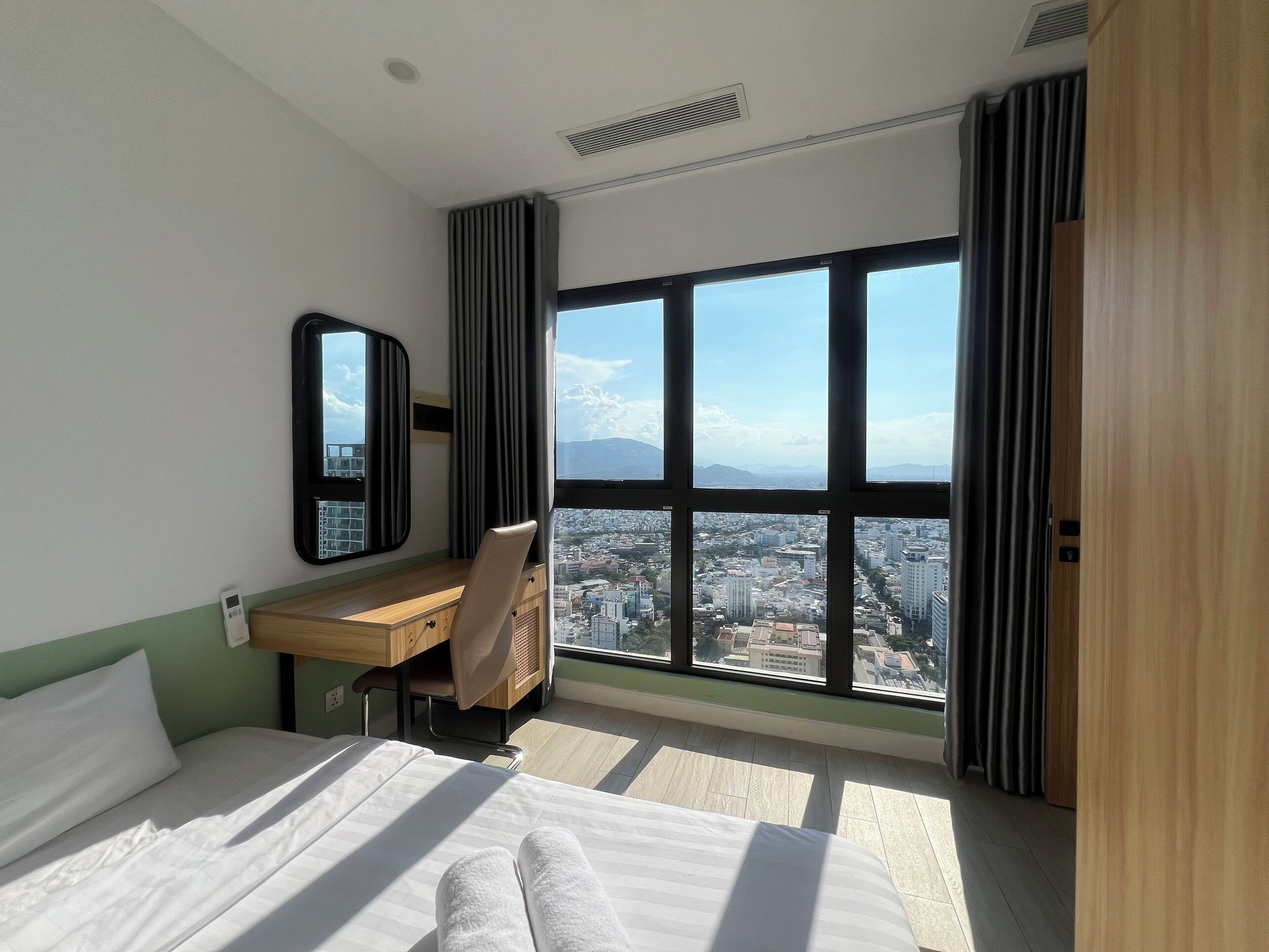 Premium bedding, desk, laptop workspace, blackout curtains