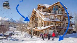 A ski resort building with multiple balconies and a ski lift in the background. - VIEWS!!! Luxury Retreat • Panoramic Mountain Views • Steps to Gondola (Mountain Village)