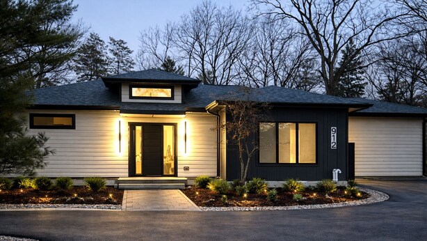 A modern two-story house with a dark exterior, a garage, and a well-lit entrance. - Tranquil 1 bedroom in-law suite - walking distance to downtown Delafield (Delafield)