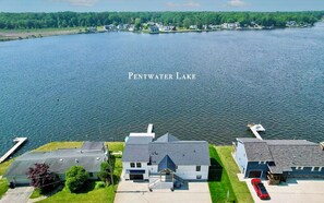 An aerial view of a residential area with houses near Pentwater Lake. - The Pentwater Porch (Pentwater)