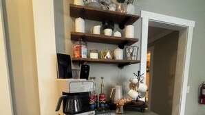 A kitchen with a light blue cabinet, a coffee maker, and various kitchen items on the countertop. - "5 Mins Driving Distance from The Ark Encounter & Creation Museum" (Williamstown)