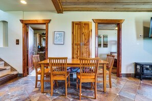 A dining area with a wooden table and chairs, a tiled floor, and a staircase leading to another room. - 6 Mi to Lake Pat Cleburne! Family Escape w/ Pond (Cleburne)