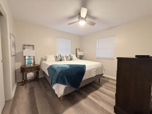 A bedroom with a bed, a dresser, a nightstand, a ceiling fan, and two windows with blinds. - 9mi to UAB & Birmingham, firepit, bottle of wine, 5 mi to Bill Noble Park, Pets (Fultondale)