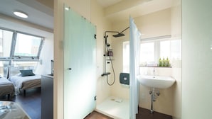A modern bathroom with a shower, sink, and a window. - 6 min to Roppongi St! Spacious 5BR apt, 12 beds,140㎡,sleeps up to 12 guests. (Roppongi, Minato)