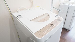 A white, compact, wall-mounted laundry machine with a control panel and a transparent window. - 6 min to Roppongi St! Spacious 5BR apt, 12 beds,140㎡,sleeps up to 12 guests. (Roppongi, Minato)