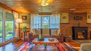 A cozy living room with a fireplace, a sofa, and a coffee table. - Summer Sale/Hot Tub/Fire Pit/Playset/Arcade/Pet Friendly/4 mins to US33 (Rockbridge)