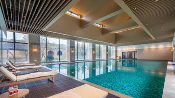 Indoor pool, pool umbrellas, pool loungers