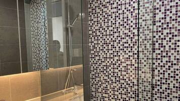 Separate tub and shower, hydromassage showerhead, designer toiletries