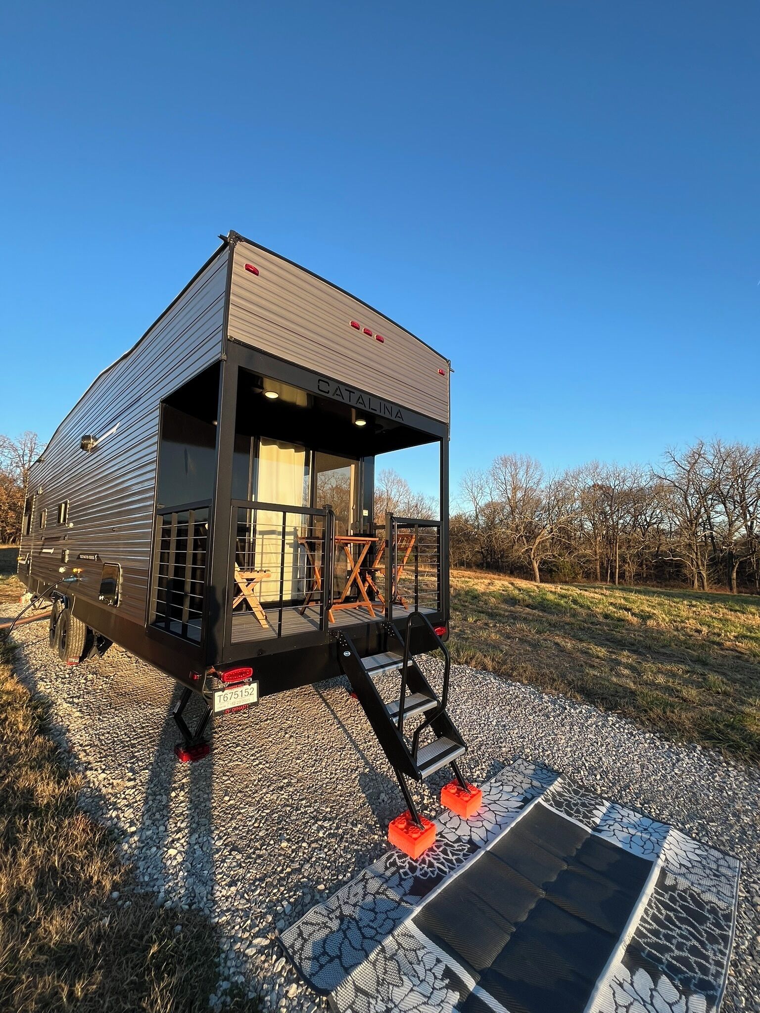 A mobile home with a covered porch and a sliding door.
