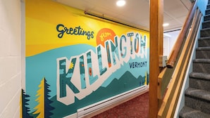 A wall with a colorful mural featuring the text "Greetings from KELINGTON, VERMONT." - Killington Haus (Killington)