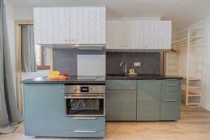 A compact kitchen with a built-in oven, a microwave, and a sink. - Alpine Flégère, 1BR Near Flégère Lift, Chamonix, France (Chamonix)