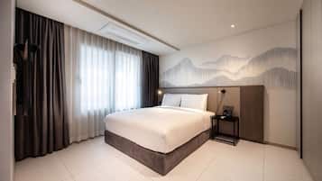 A modern hotel room with a large bed, a nightstand, a wall-mounted air conditioner, and a decorative wall panel.