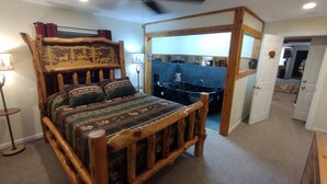 A wooden bed with a headboard, a bedside table, and a lamp.