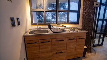 Fridge, microwave, coffee/tea maker, cookware/dishes/utensils