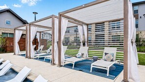 A pool area with lounge chairs and a covered seating area. - Cozy & Quiet Home w/ Pool, Gym, W/D WorkerFriendly (Sherman)