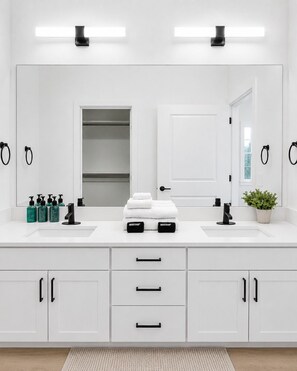 A modern bathroom with two sinks, a large mirror, and a potted plant. - Modern Stay WorkerFriendly Home w/Lndry GYM & Pool (Sherman)