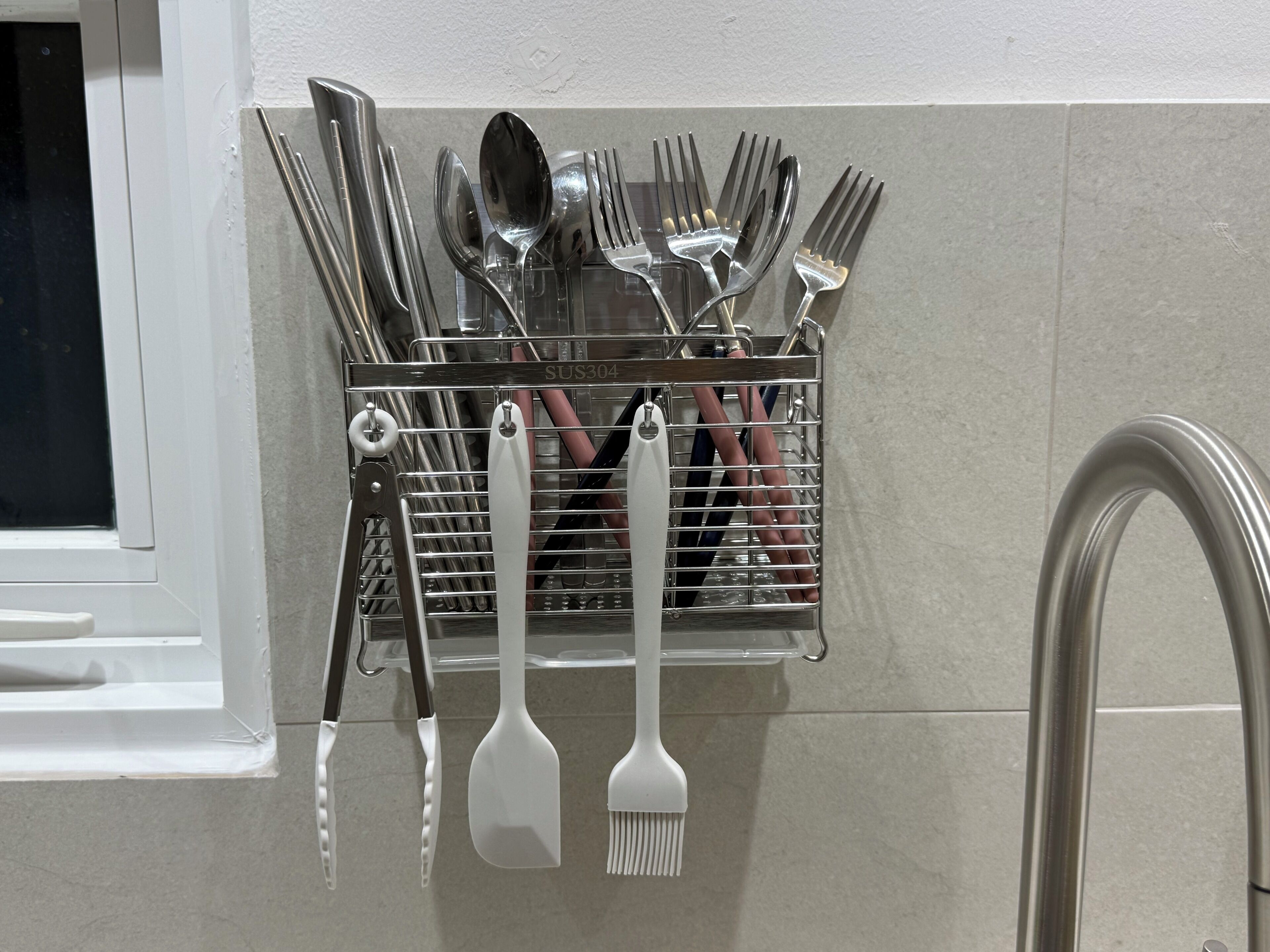 A kitchen utensil holder with various utensils like forks, spoons, and spatulas.