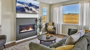 A living room with a fireplace, a large window with a view of a field, and a comfortable seating area. - Family Friendly 5BR Mountain Views & Game Room with AC (Superior)