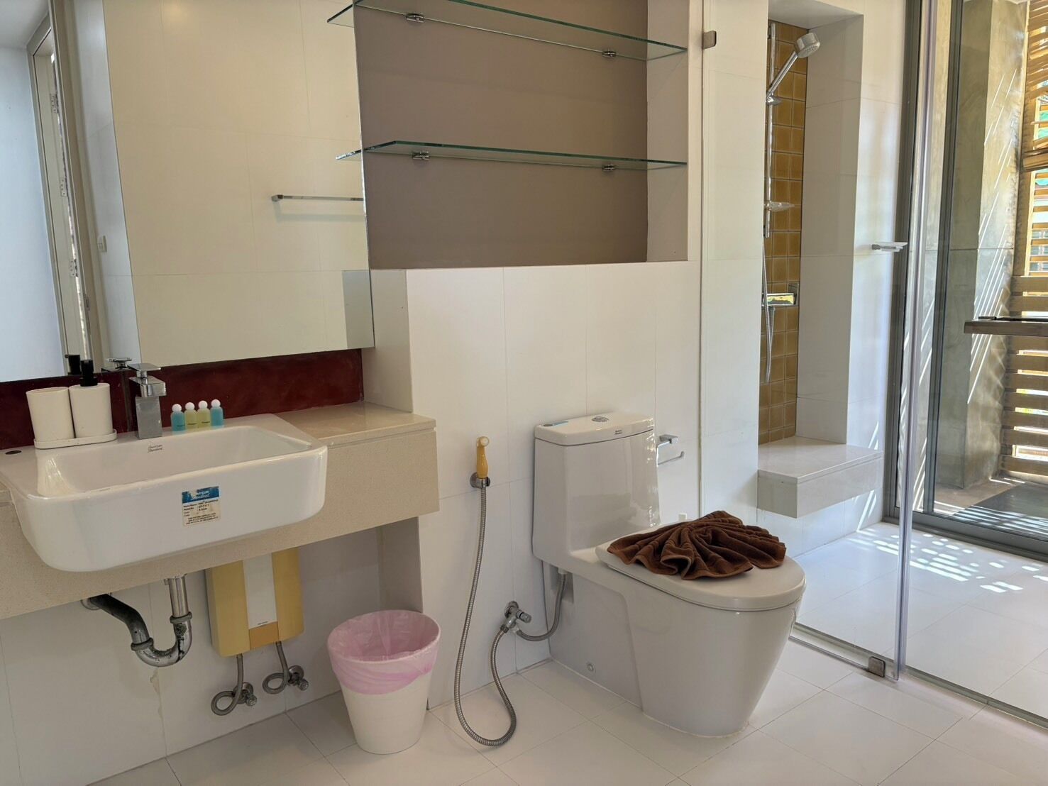 A modern bathroom with a sink, toilet, and shower area.