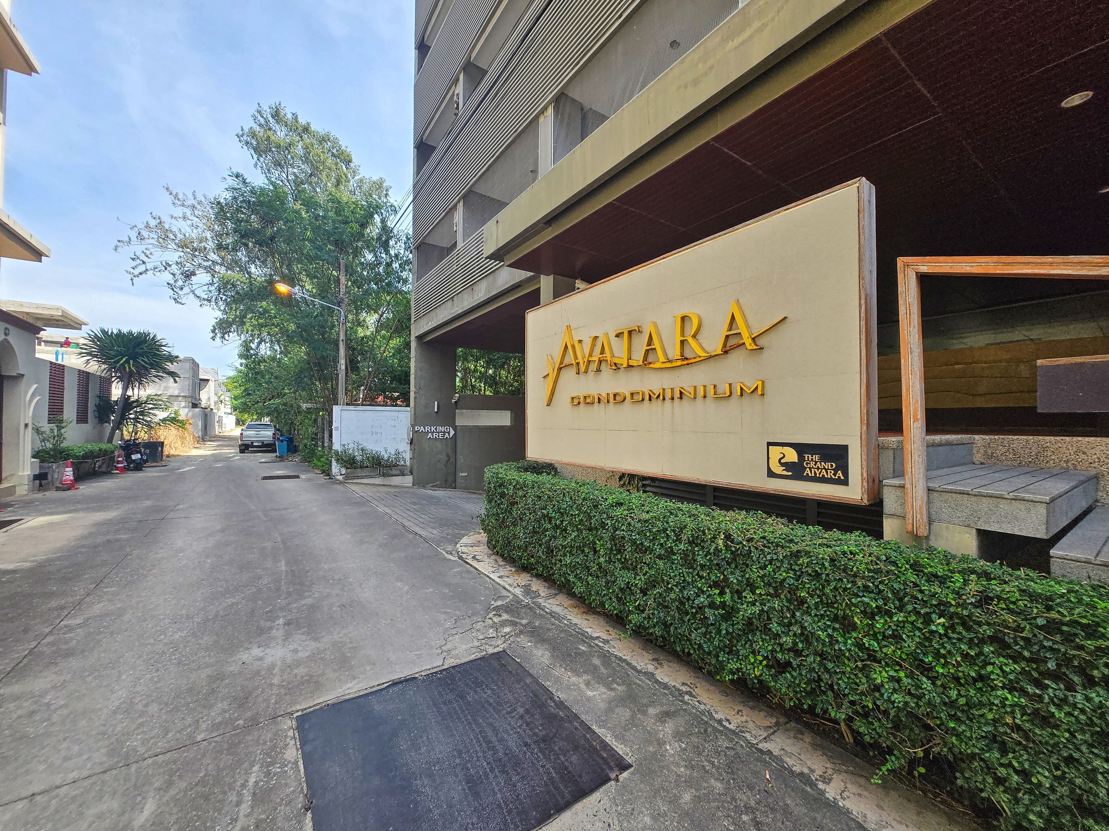 A building entrance with a sign for 'AVATAR CONDOMINIUM'.