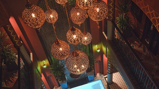 An indoor pool area with patterned hanging lights and a tiled floor. - Riad Luxury Hotel Hanoi (Hanoi)
