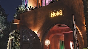 A hotel with a modern design, featuring a prominent 'Hotel' sign, large arched entrance, and a balcony with a railing. - Riad Luxury Hotel Hanoi (Hanoi)