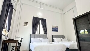 A modern hotel room with two beds, a desk, and a large window with curtains. - Ferringhi Inn 51 (George Town)