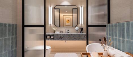 A modern bathroom with a marble sink, a large mirror, and a bathtub.