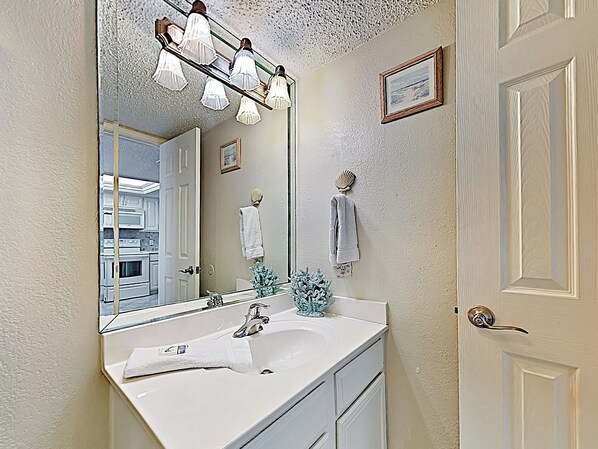 A bathroom with a white sink, a mirror, and a towel rack. - Gulf-Front 2BR w/ Balcony: Suntide III - Unit 502 (South Padre Island)