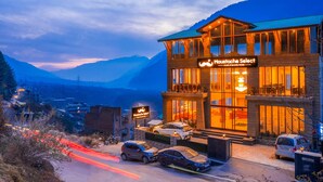 A hotel with a sign reading "Moustache Select" and a view of mountains in the background. - Moustache Select Manali (Manali)