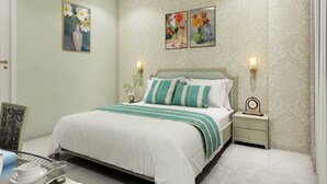 A neatly arranged bedroom with a bed, bedside tables, and wall art. - STUDIO BY JARDIN  (Indore)