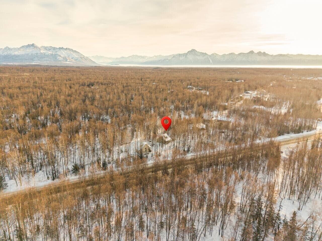 A vast, open landscape with a red marker indicating a specific location.