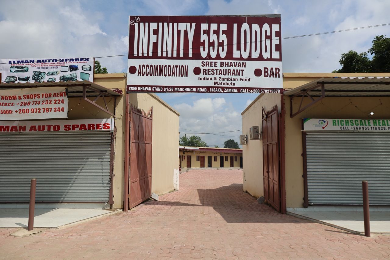 Infinity 555 Lodge with a signboard advertising accommodation, a restaurant, and a bar.