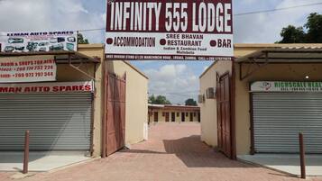 Infinity 555 Lodge with a signboard advertising accommodation, a restaurant, and a bar.