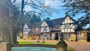 A traditional Tudor-style building with a sign for Little Silver Country Hotel & Restaurant.
